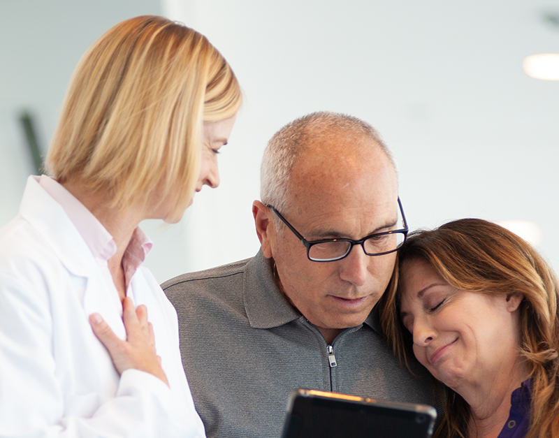 A doctor comforting a couple