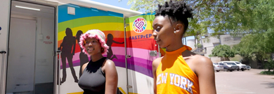 Two women outside of mobile clinic