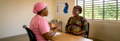 Doctor with pregnant lady in a doctor's surgery