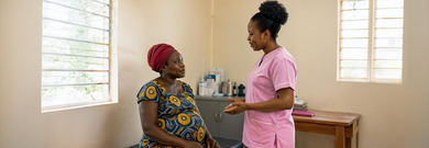 Doctor with pregnant lady in a doctor's surgery