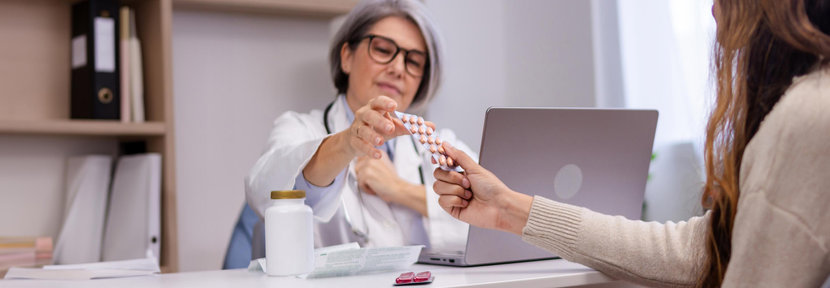 Doctor behind desk speaking to patient