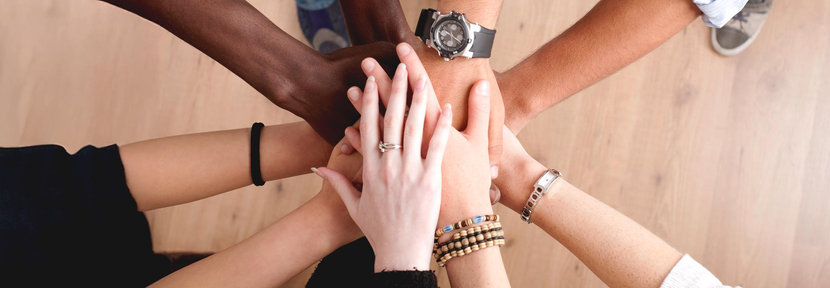 Several hands coming together