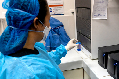 Women at GeneXpert wearing PPE