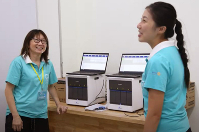 WeCARE volunteers with the GeneXpert® system.