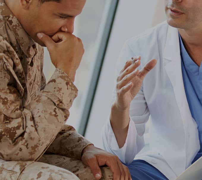 Military person speaking with Doctor