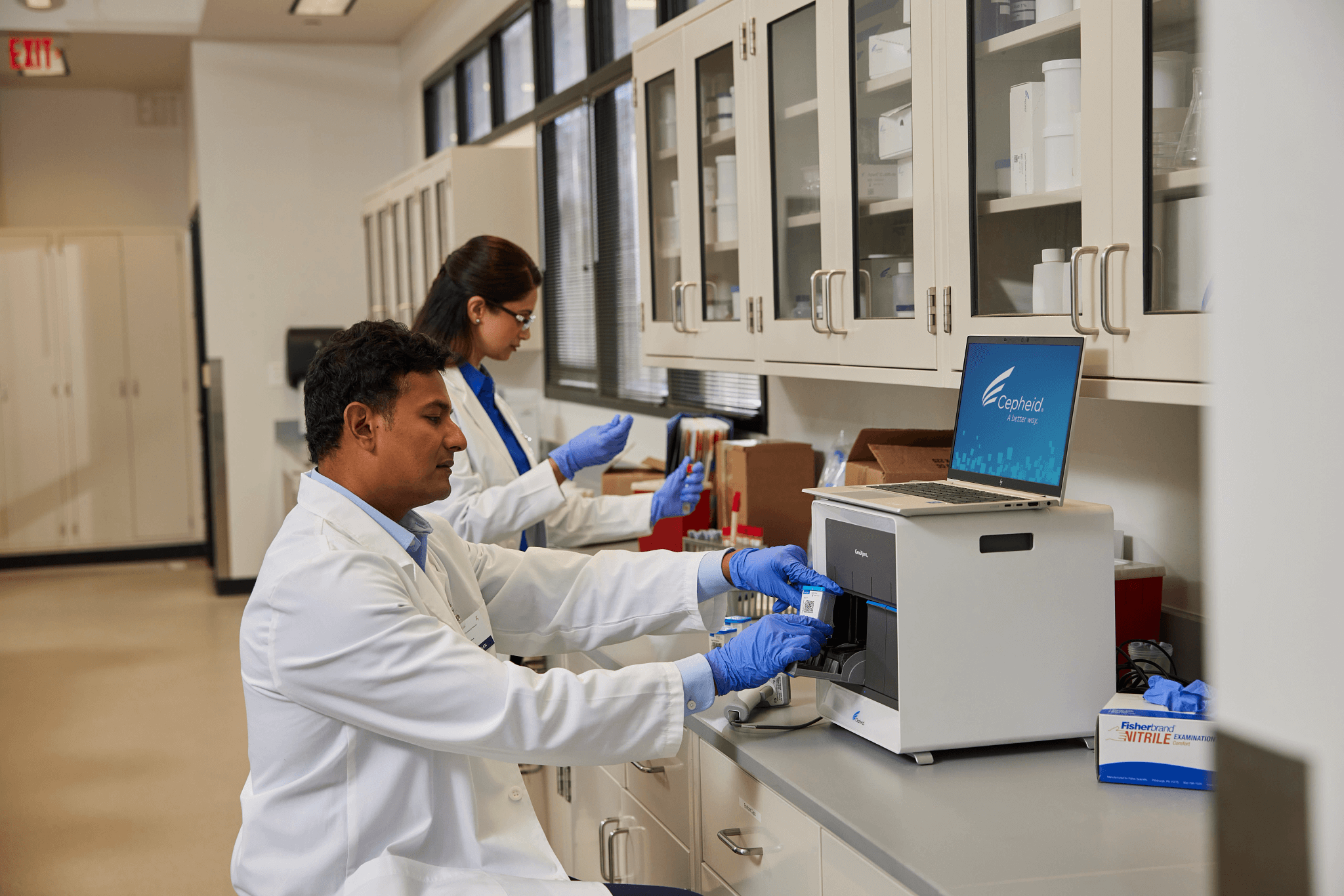 Lab tech using system to run test