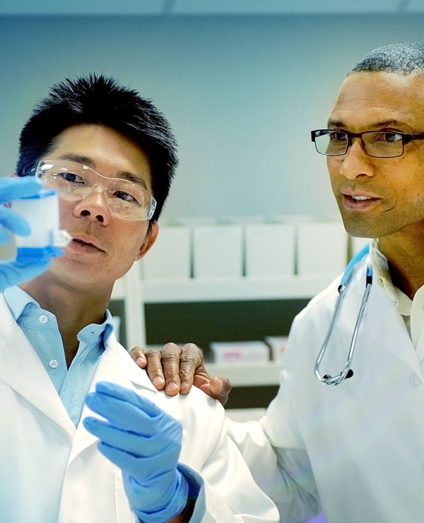 Scientists inspect a PCR test cartridge